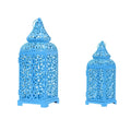 Blue geometric Moroccan style metal lantern candlestick holder on a table.