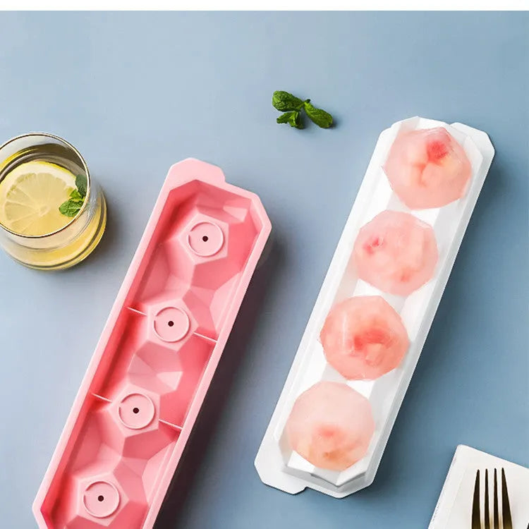 Flexible silicone ice tray producing large hockey puck-shaped ice cubes in various colours.