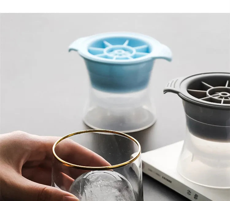 Flexible silicone ice tray producing large hockey puck-shaped ice cubes in various colours.