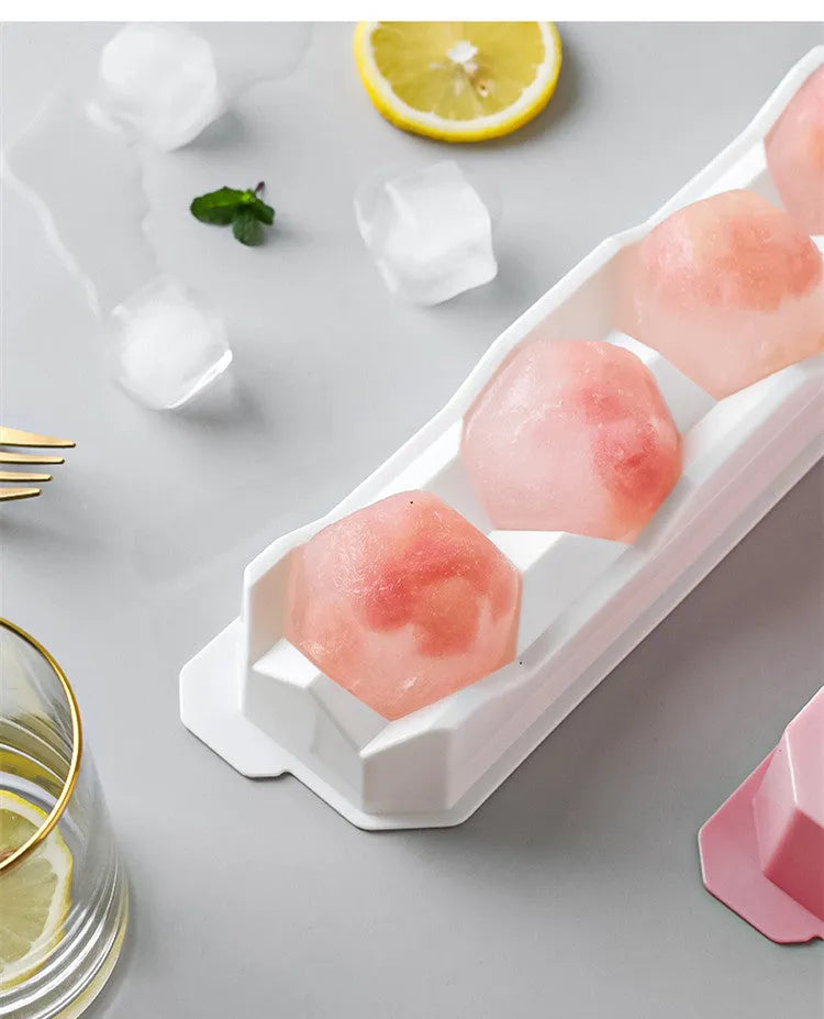 Flexible silicone ice tray producing large hockey puck-shaped ice cubes in various colours.