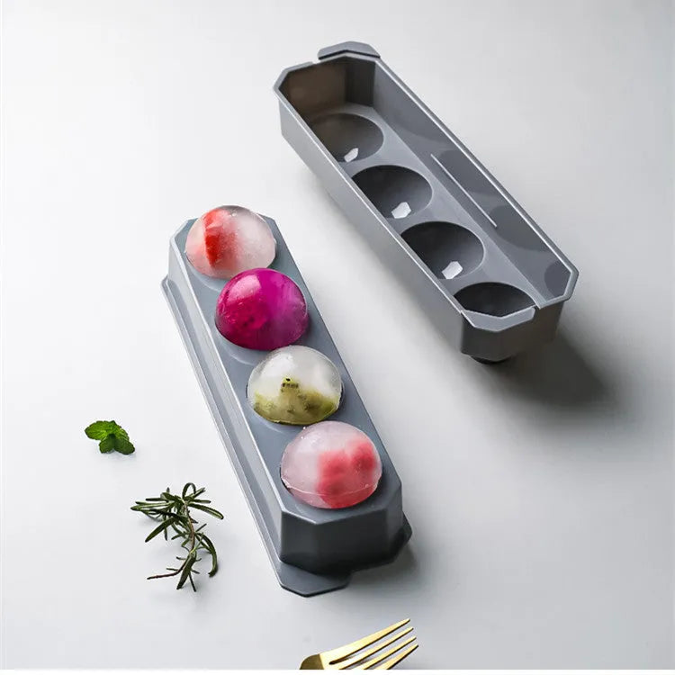 Flexible silicone ice tray producing large hockey puck-shaped ice cubes in various colours.