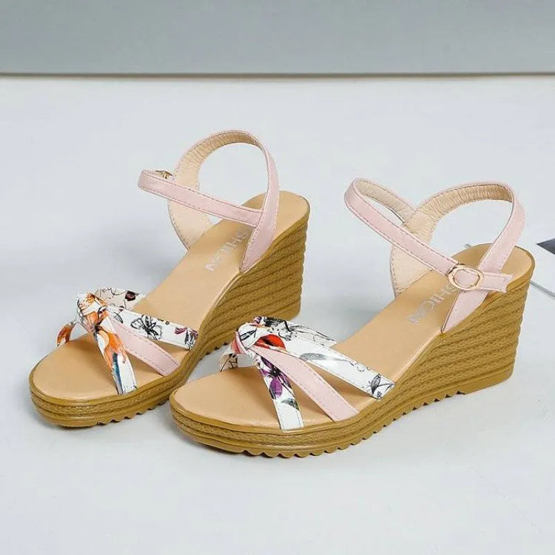 Women's pink wedge sandals with a thick heel, one-strap buckle, and a non-slip sole.