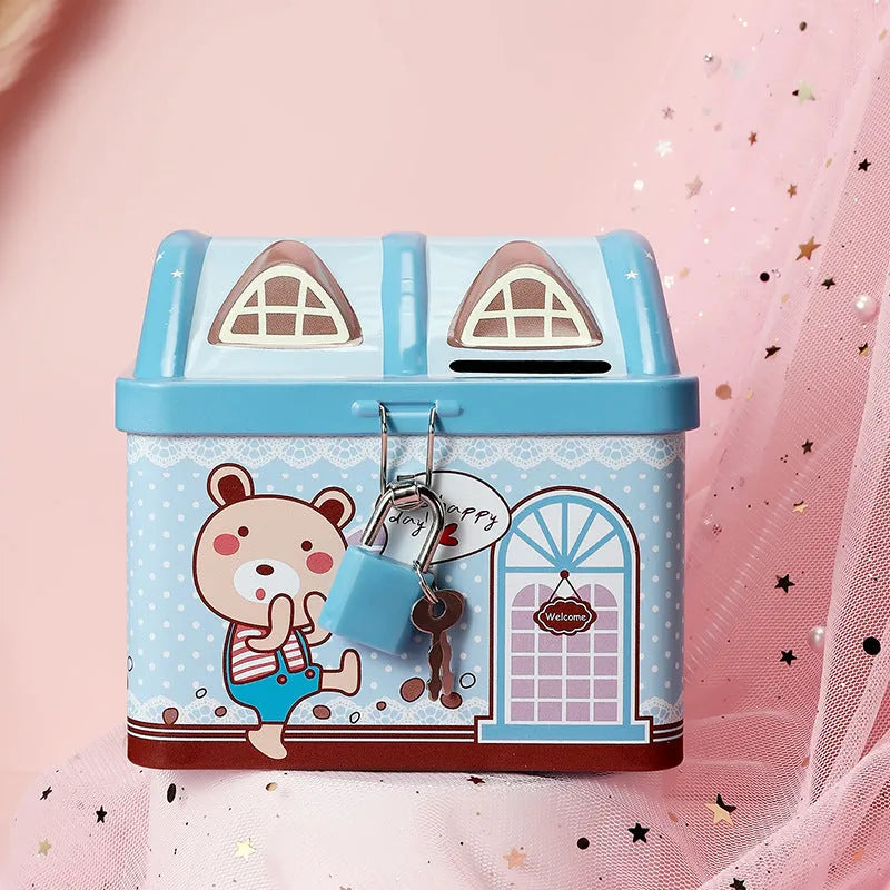Blue house-shaped tinplate piggy bank for coin storage on a desk