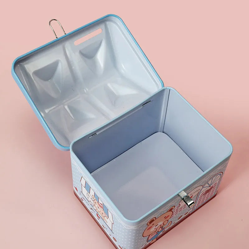 Blue house-shaped tinplate piggy bank for coin storage on a desk