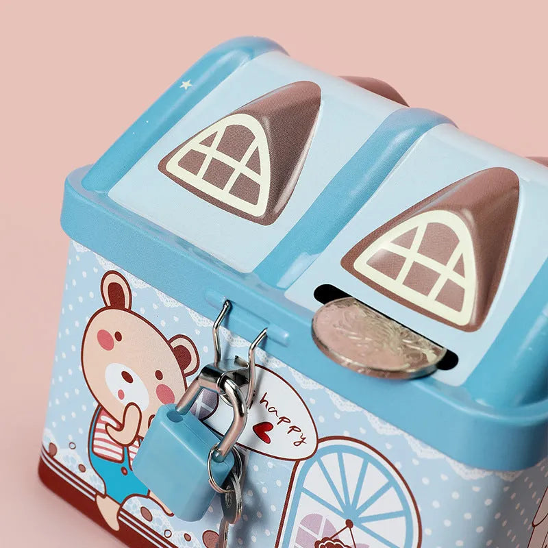 Blue house-shaped tinplate piggy bank for coin storage on a desk