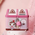Blue house-shaped tinplate piggy bank for coin storage on a desk