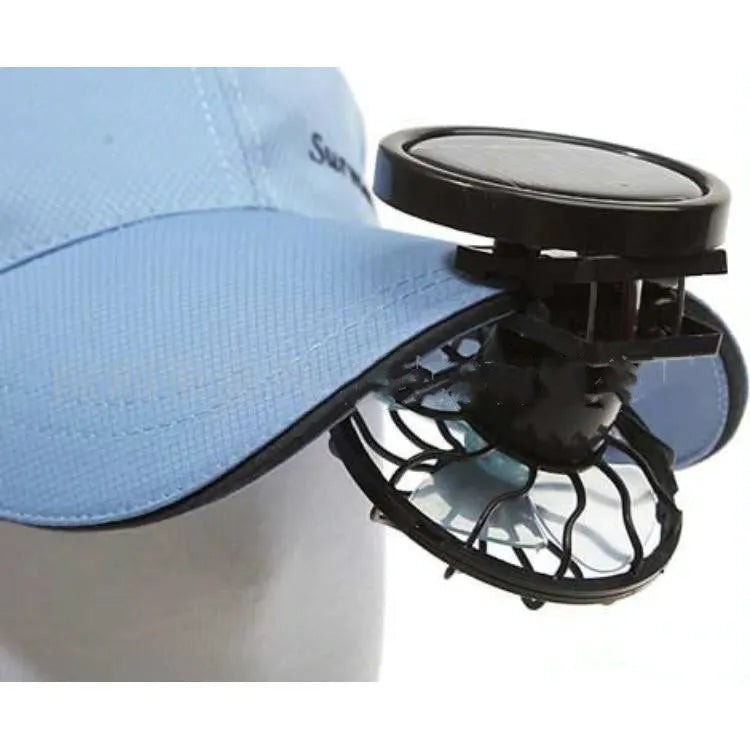 Black clip-on solar powered portable fan for outdoor cooling during camping and travel