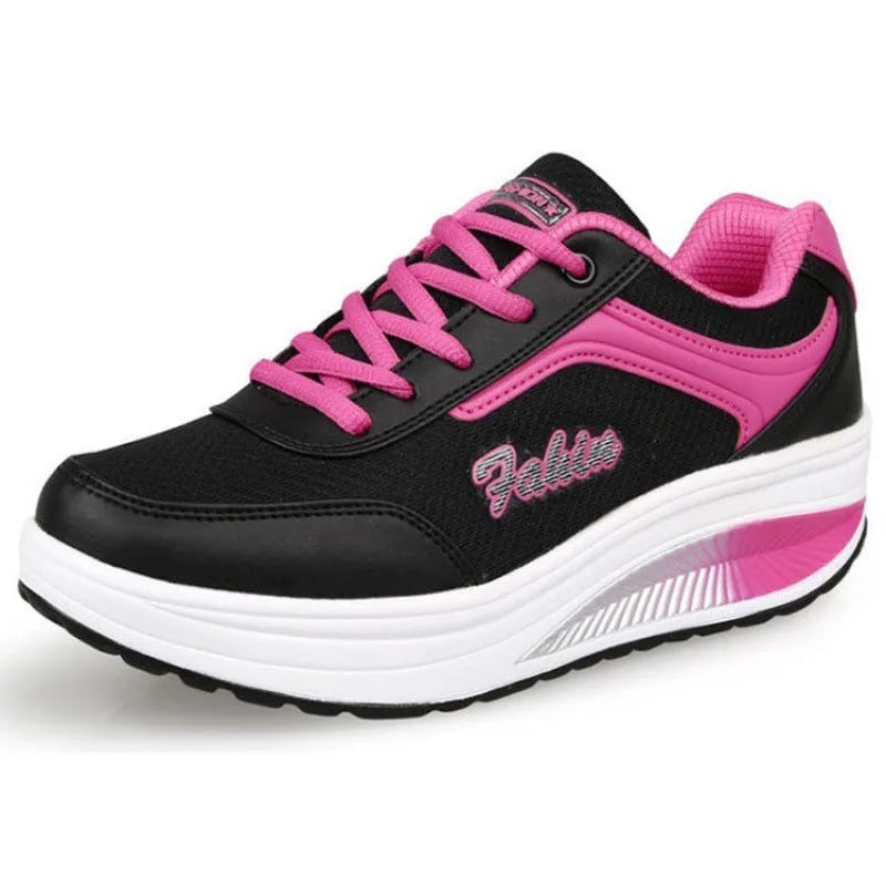 Women's grey and black middle heel travel and sports shoes showing side profile.