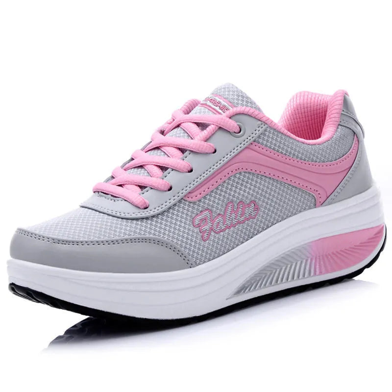 Women's grey and black middle heel travel and sports shoes showing side profile.