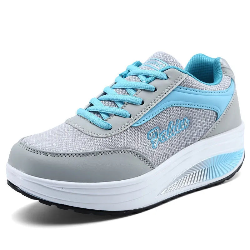 Women's grey and black middle heel travel and sports shoes showing side profile.