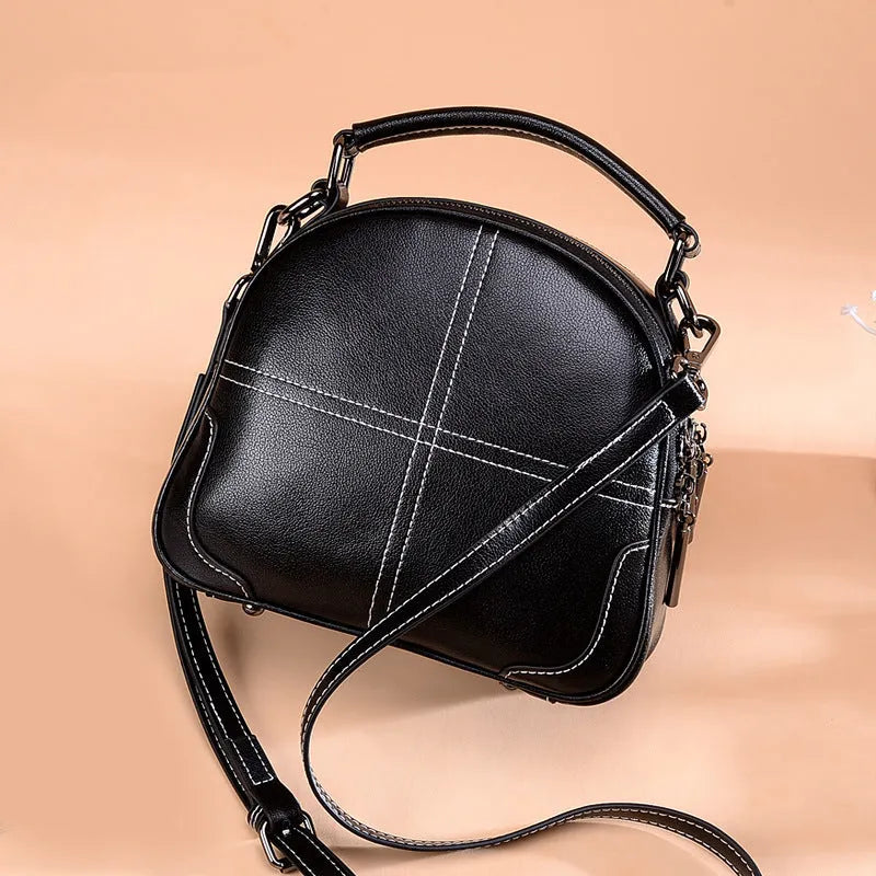 Round two-layer cowhide leather handbag with zipper closure available in wine red black and brown