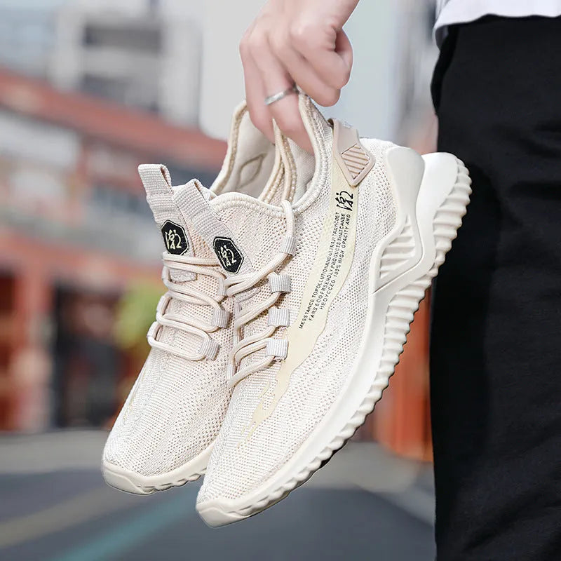 Men's low-top white mesh sports sneakers with rubber sole on a plain background