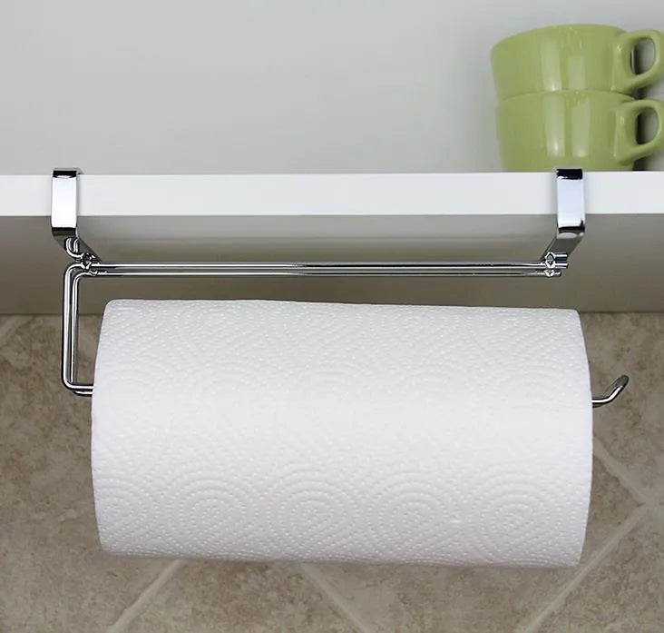 Silver stainless steel paper towel rack hanging over cabinet door for kitchen storage