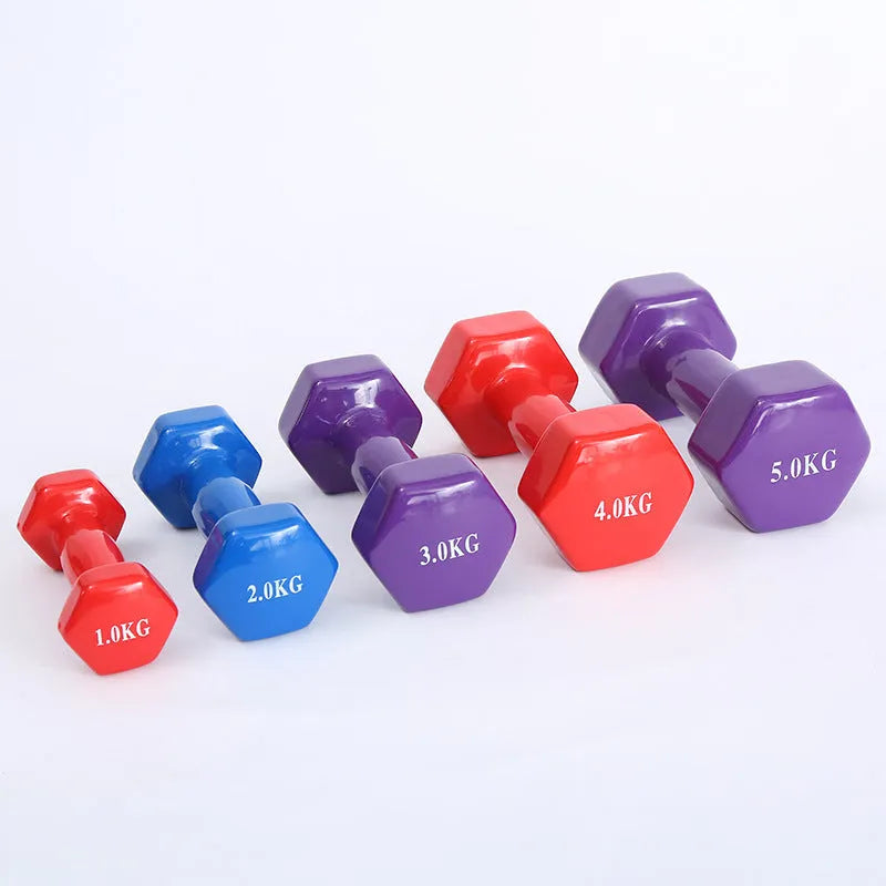 Bright coloured plastic-coated fitness dumbbell showing glossy finish on a home gym floor.