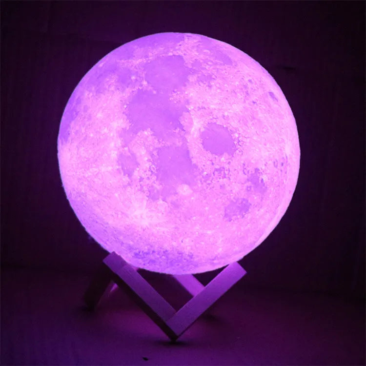 3D printed white moon lamp on a wooden stand, showing detailed craters and soft LED glow.