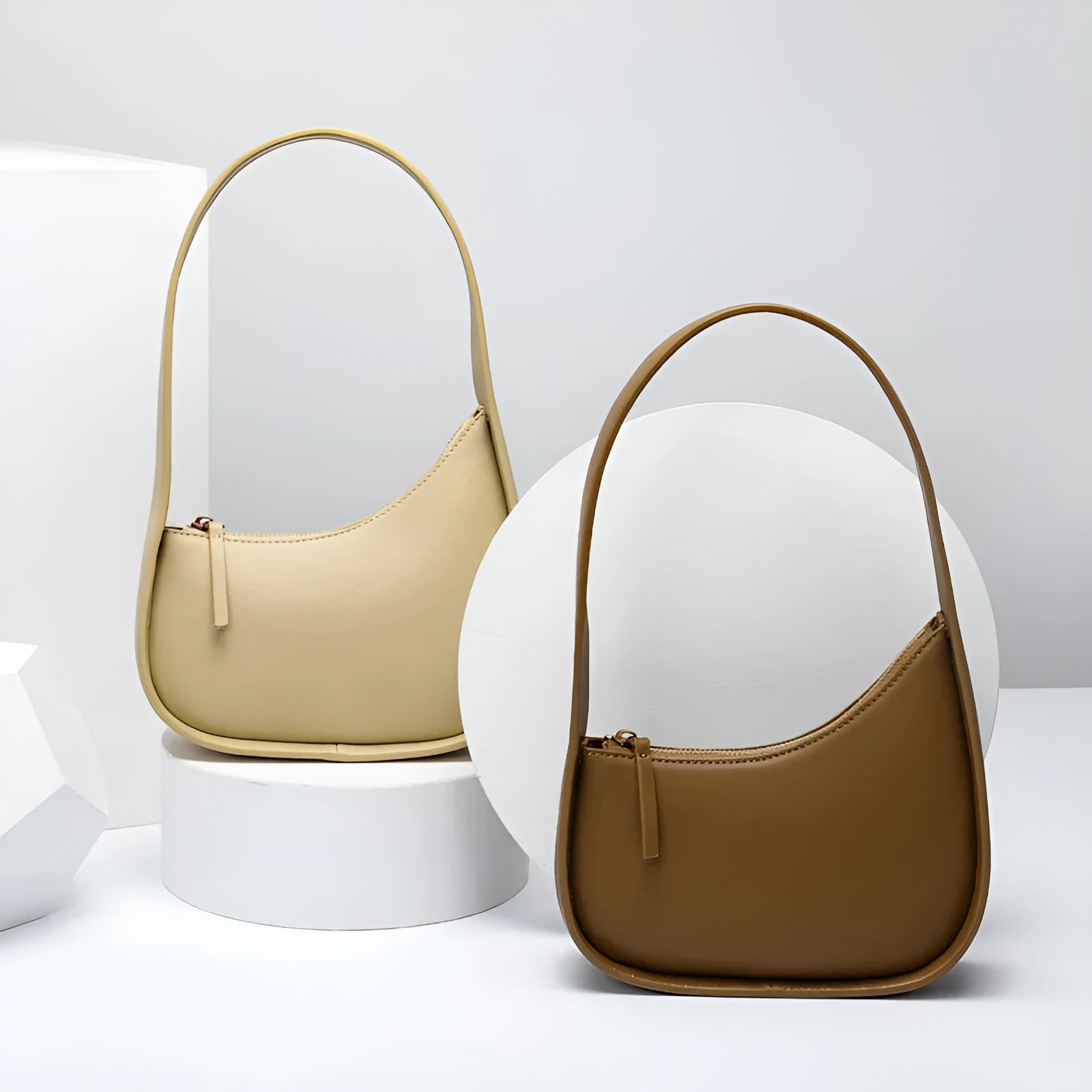 Small genuine cowhide leather half moon handbag with a wide shoulder strap.