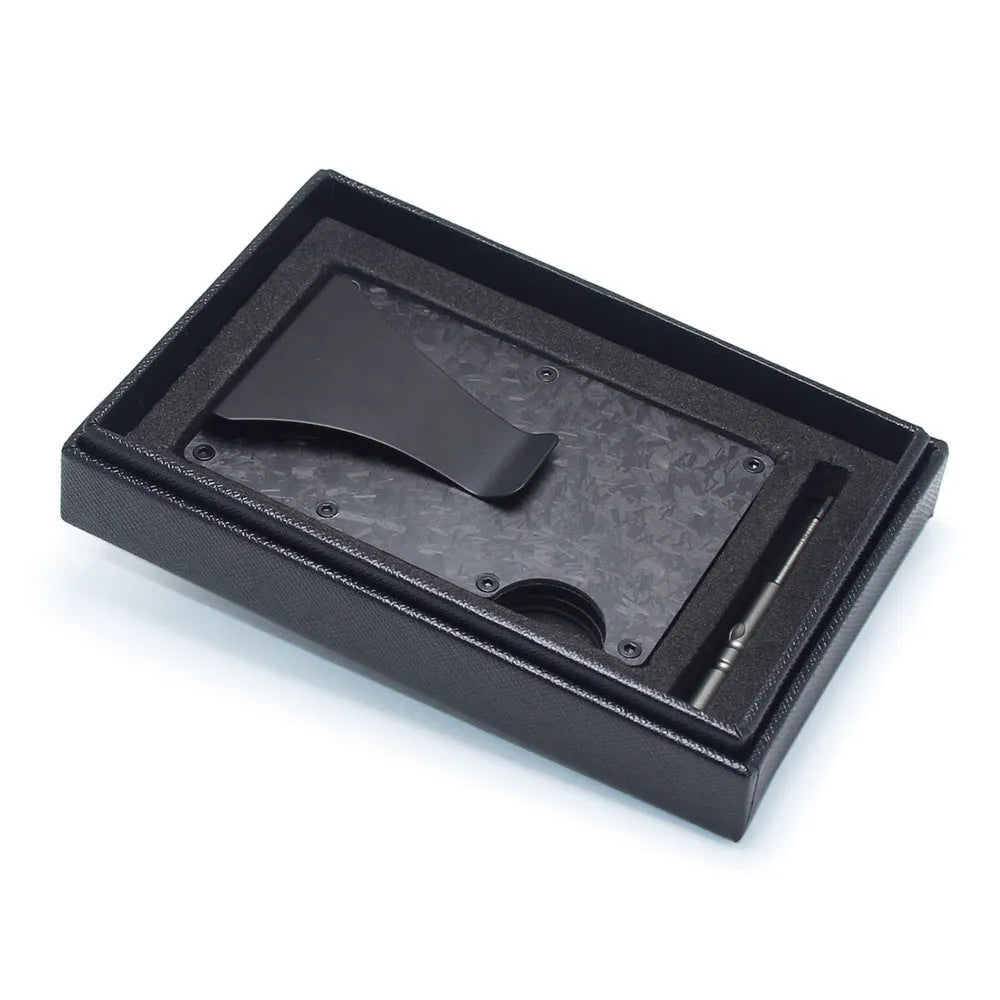 Geometrical black carbon fibre card wallet for business cards and banknotes on a gift box.