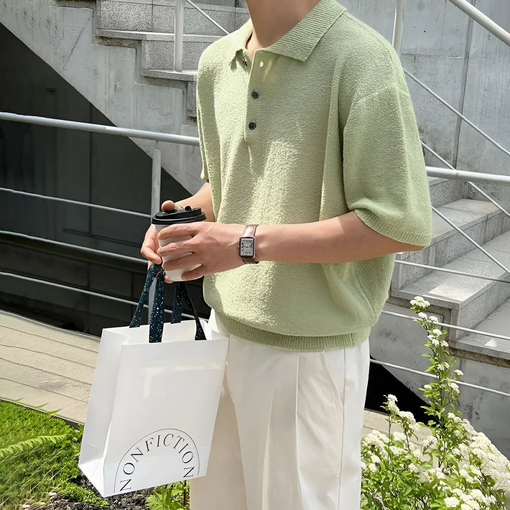 Man wearing a caramel-coloured retro knitted polo shirt with short sleeves and an asymmetric design detail.