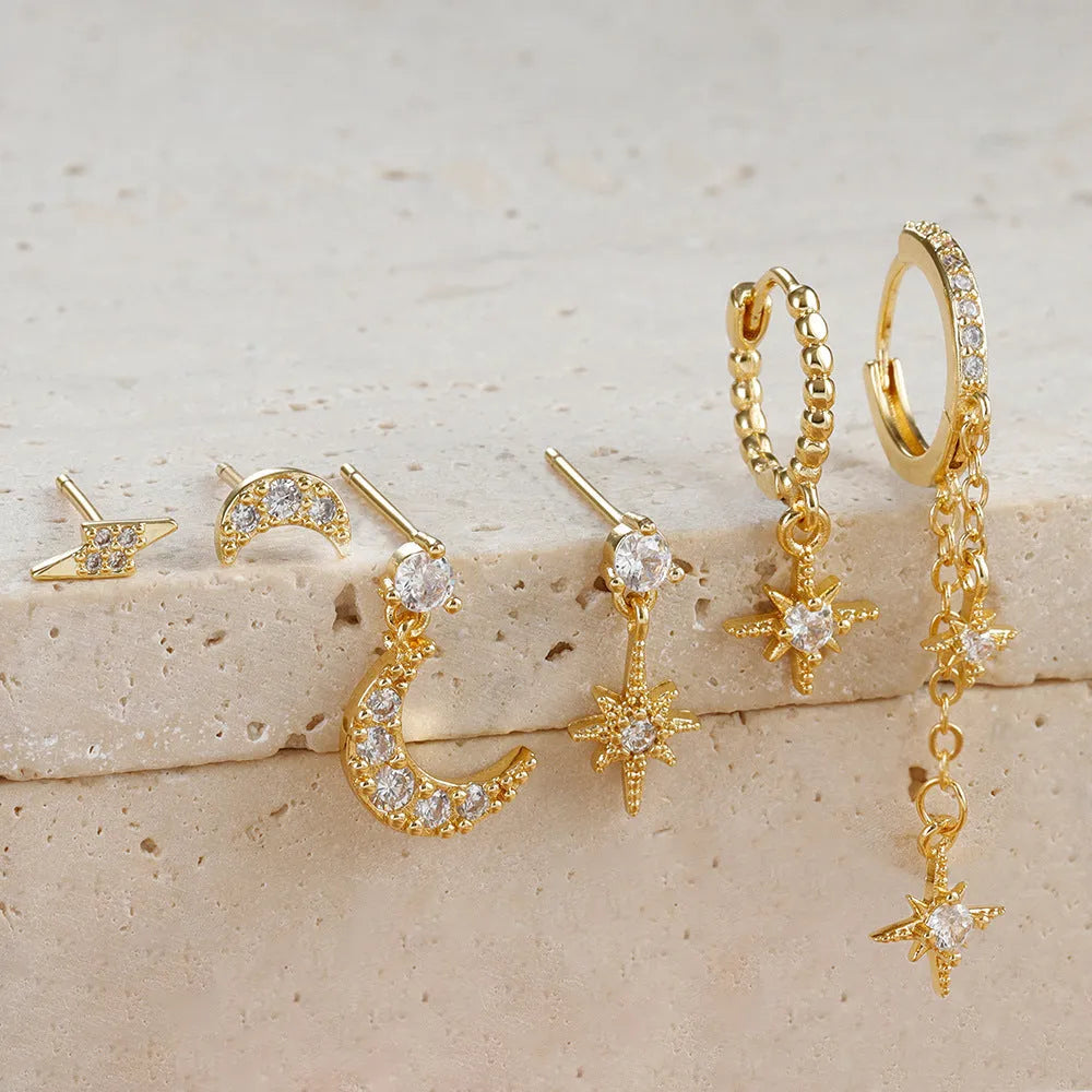 Gold-coloured chain tassel earrings with six dangling elements and zircon stud details on copper construction.