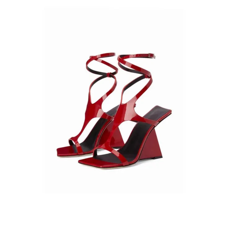 Women's black high heel sandals with a square toe and button strap fastening.