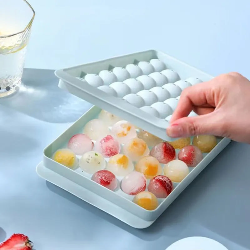 Blue silicone round ice cube tray with lid showing 33 circular moulds