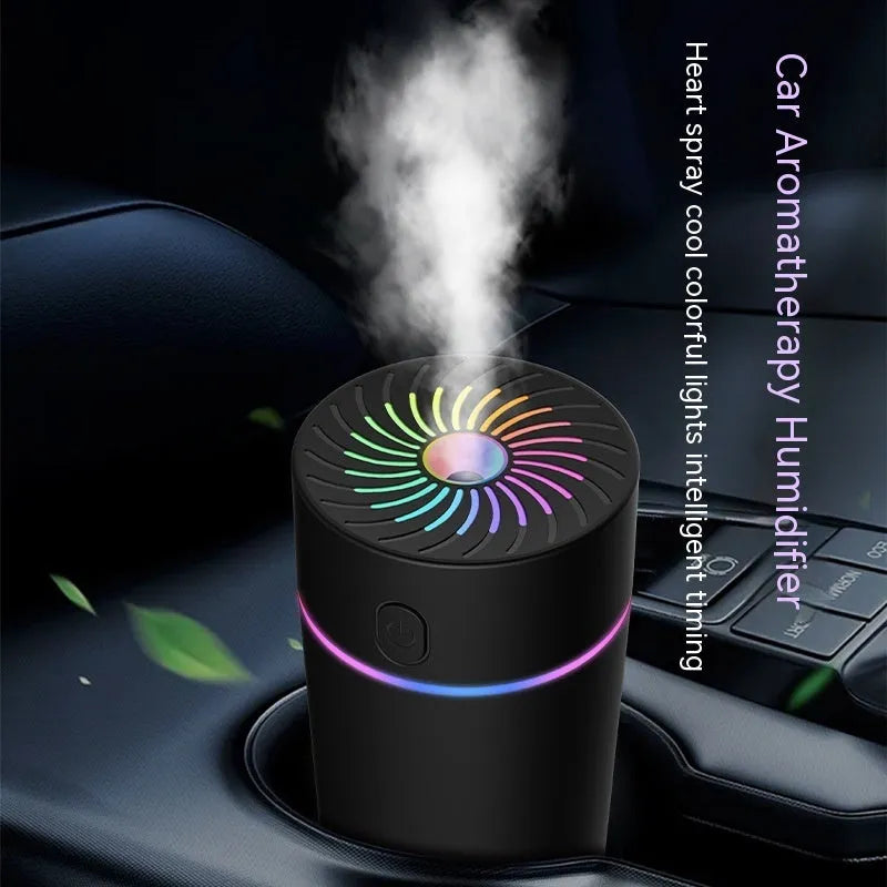 Compact white car USB humidifier with aromatherapy function shown in vehicle cup holder