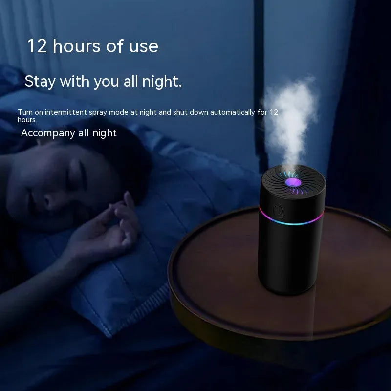 Compact white car USB humidifier with aromatherapy function shown in vehicle cup holder