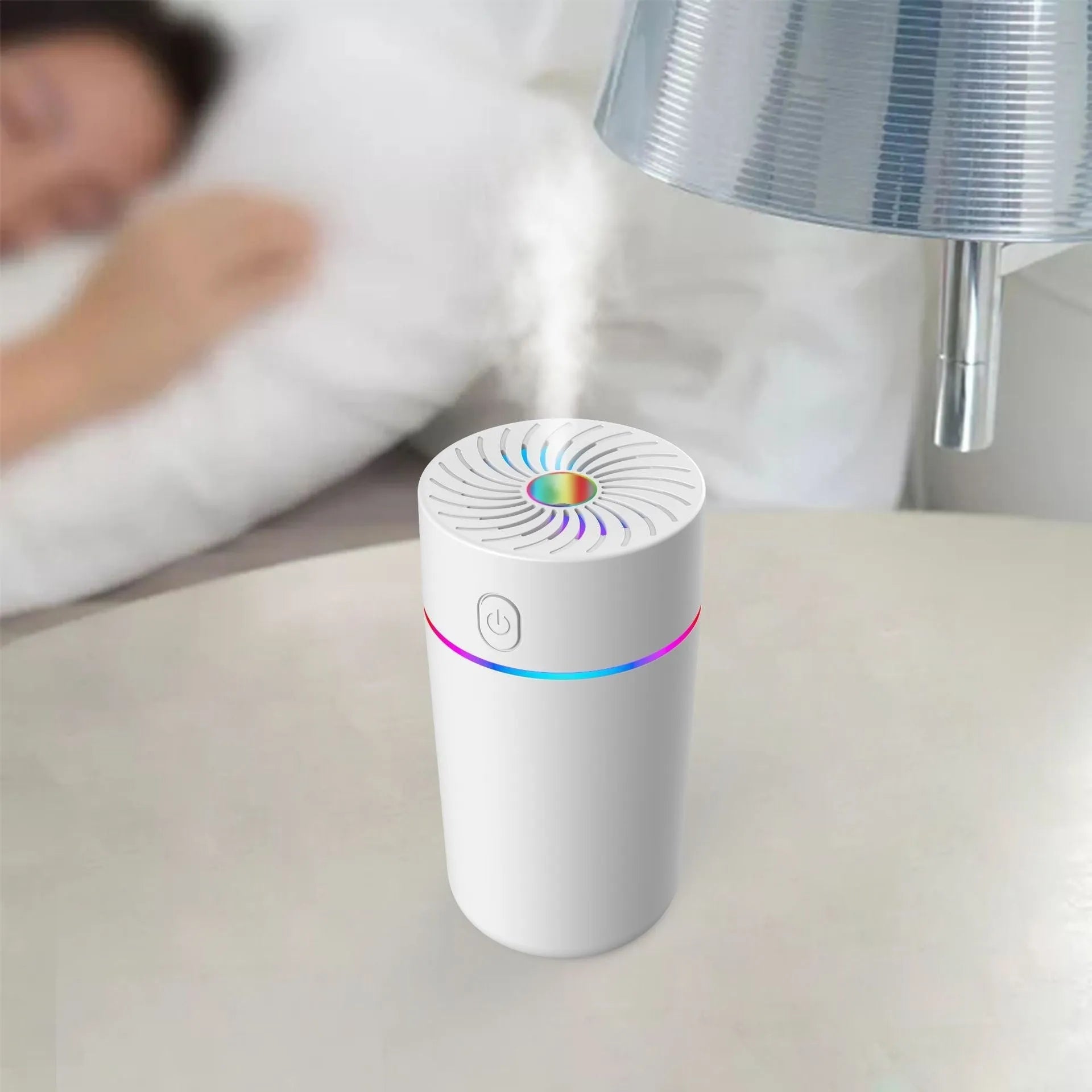 Compact white car USB humidifier with aromatherapy function shown in vehicle cup holder