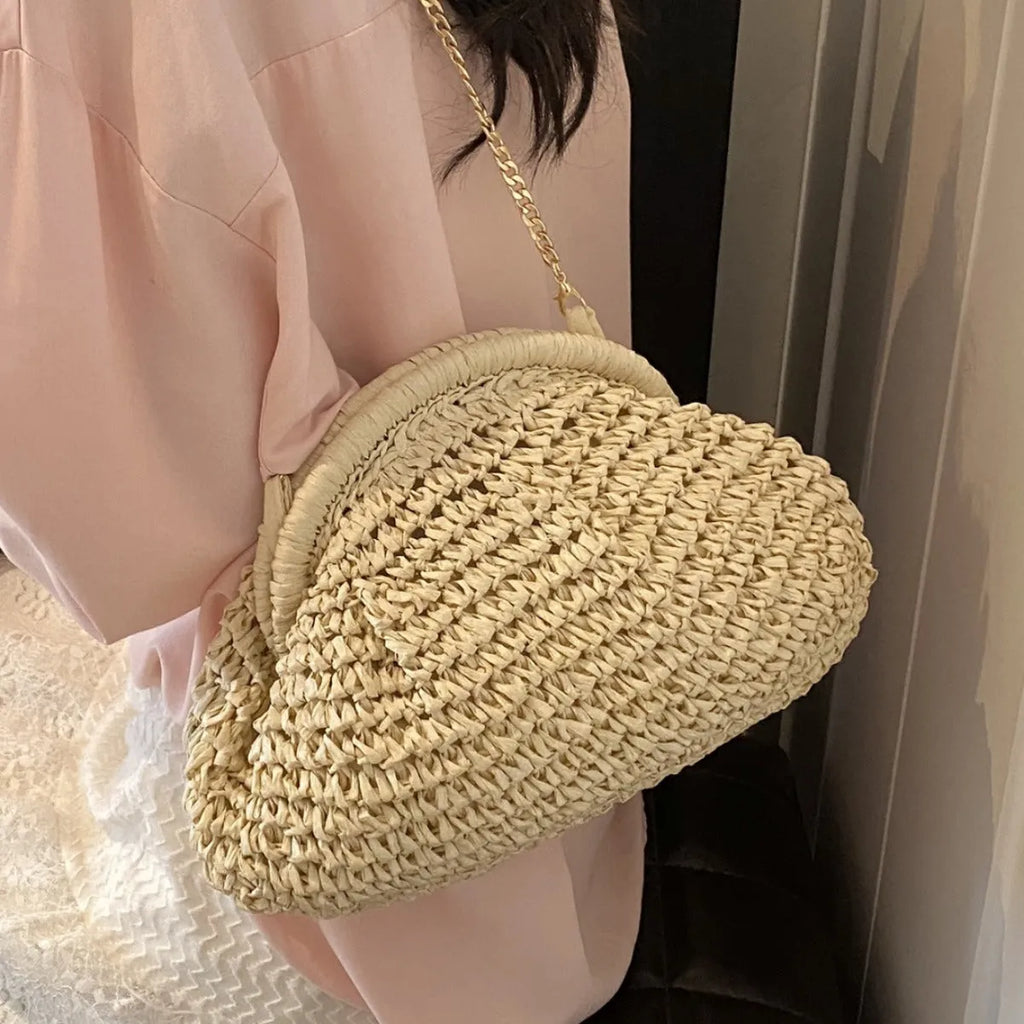 Khaki shell-shaped straw shoulder bag for women with chain detail and an internal zipper pocket.