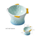 Set of blue, green, pink, and yellow ceramic fish shaped cat bowls with a tilted design.