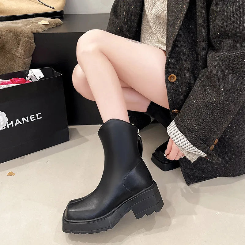 Black platform Martin booties for women with a square toe, back zipper, and a mid-calf height.