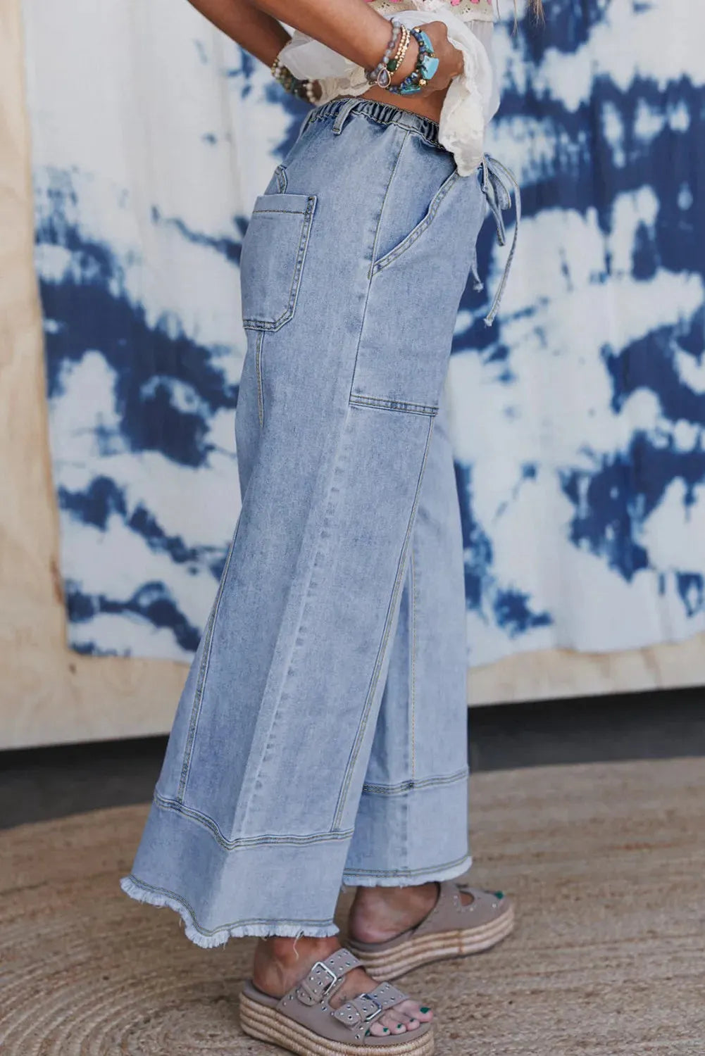 Beau blue wide leg denim trousers with drawstring waistband and raw hem finish