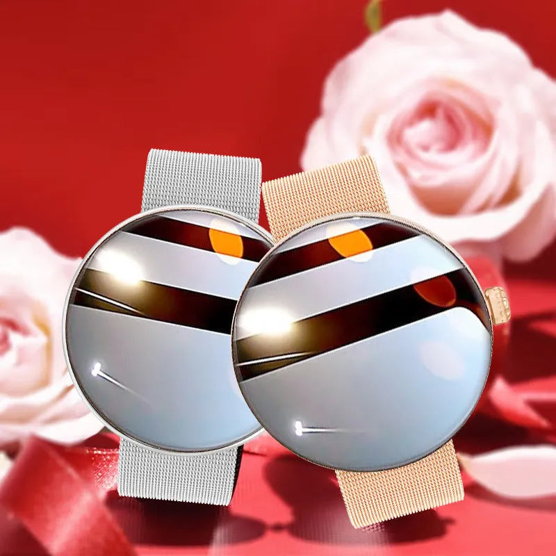 Circular women's smartwatch with metal strap and colour touchscreen display on a wrist.