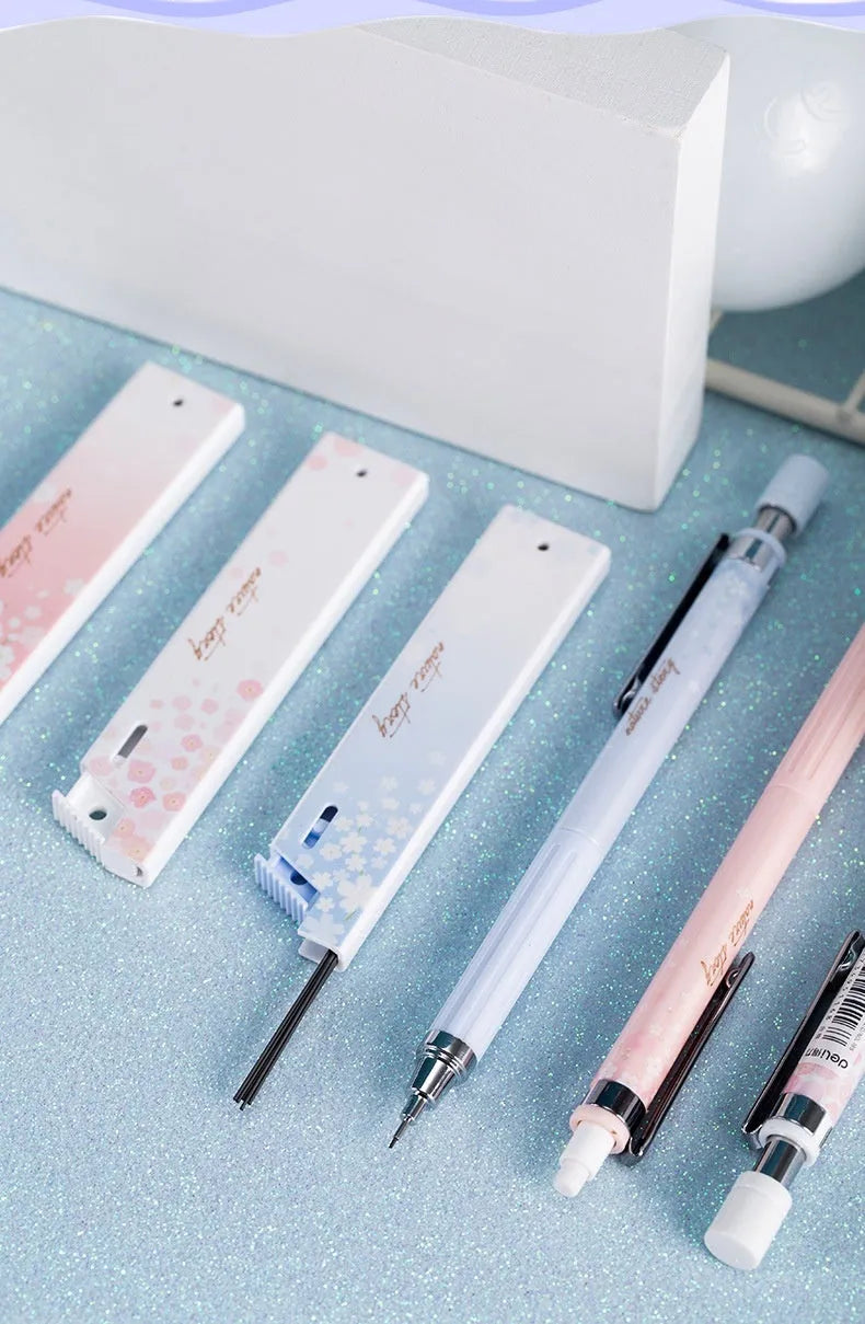 Set of three cartoon-design 0.5mm automatic pencils with boxes of HB refills.