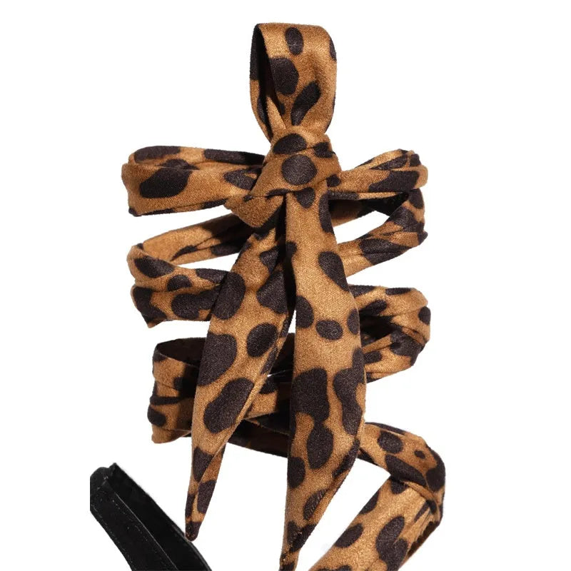 Light brown leopard print women's high heels with cross straps and a fine high heel