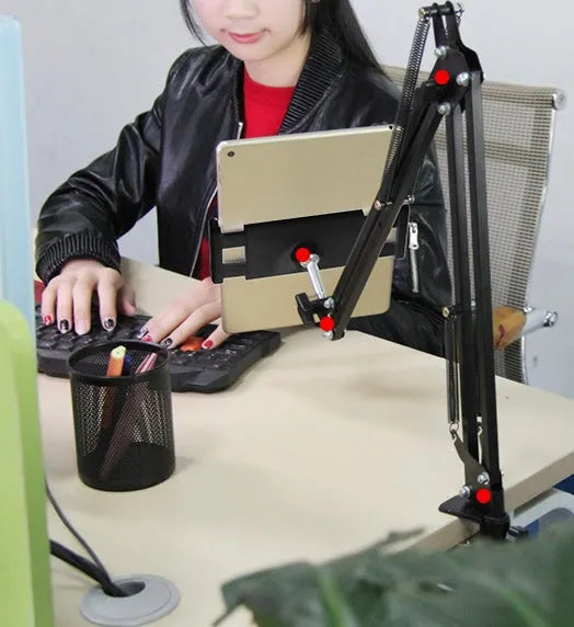 Black adjustable phone tablet stand with 360-degree rotation on wooden table