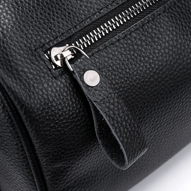 Black genuine leather women's crossbody bag showing front view and shoulder strap