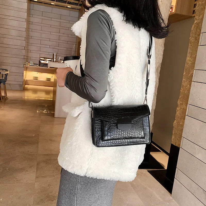 Vintage PU leather crossbody bag in black showing 20cm width and crossbody strap