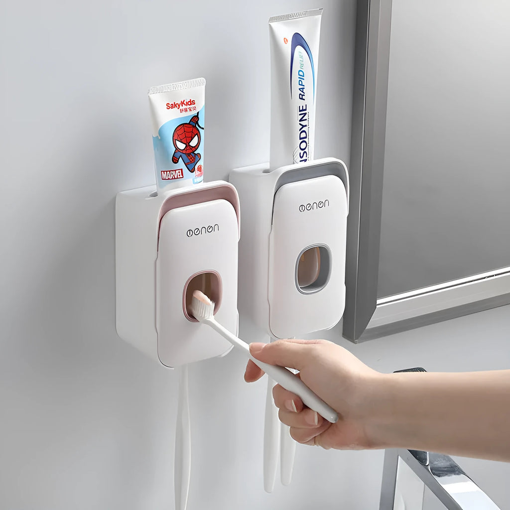 Blue automatic toothpaste dispenser with wall-mount bracket on a bathroom wall