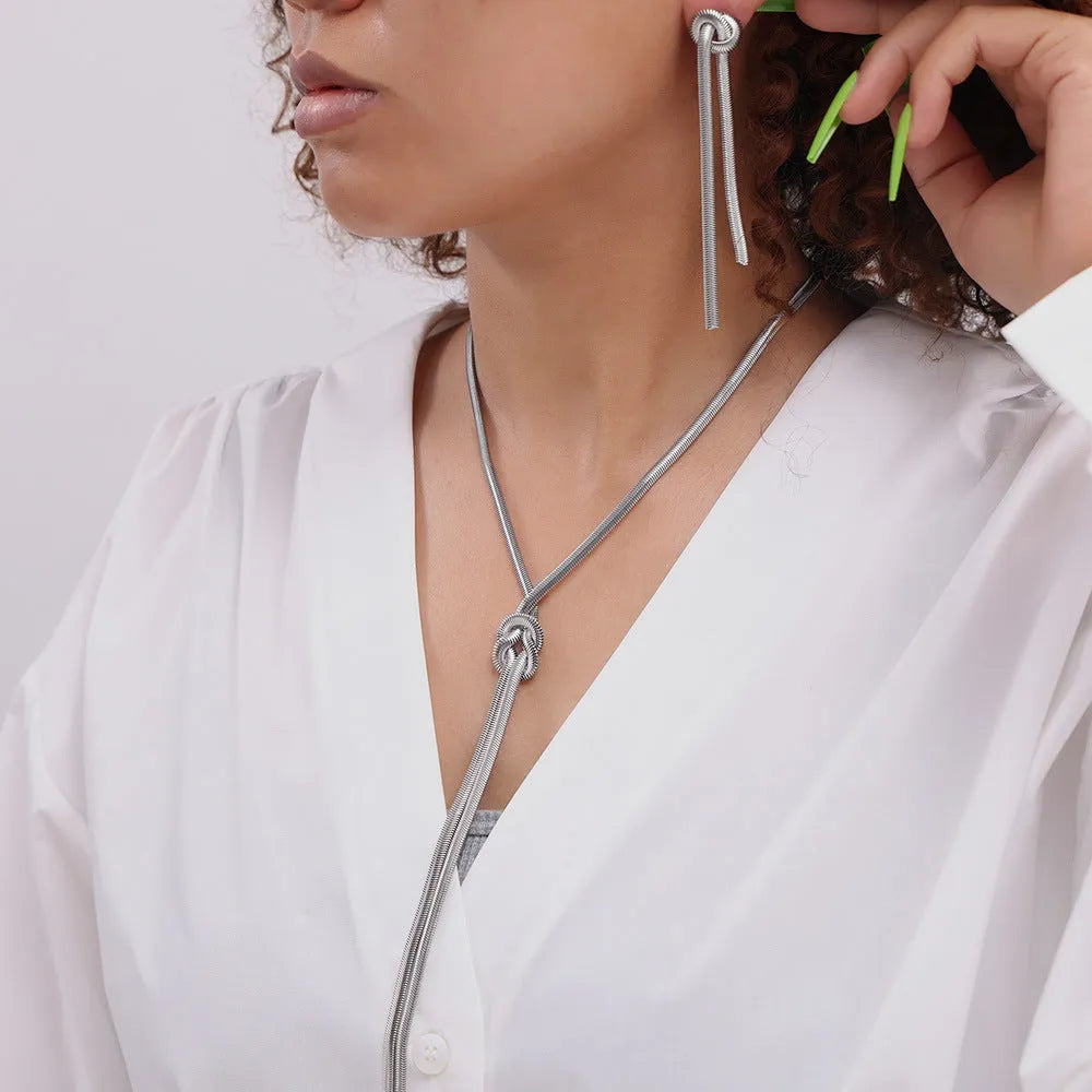 Gold knotted tassel pendant on titanium steel snake chain necklace with matching earrings