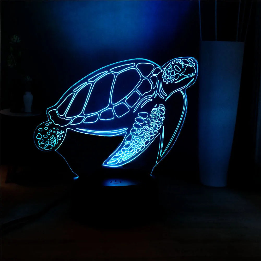 Turtle-shaped acrylic night light with multi-coloured 3D LED glow, showing remote control.