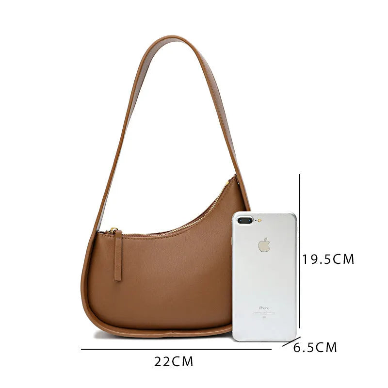 Small genuine cowhide leather half moon handbag with a wide shoulder strap.