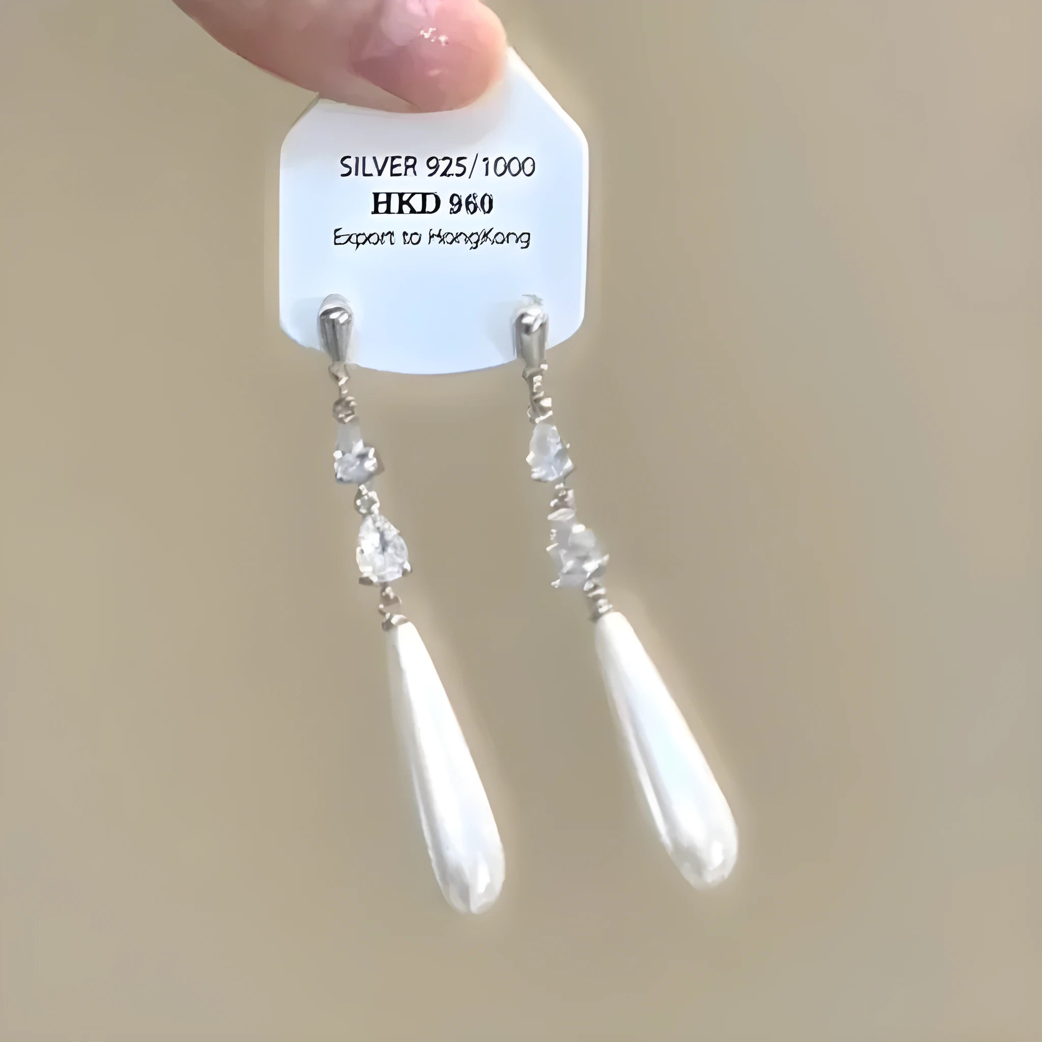 Geometric heart-shaped women's clip-on earrings with rhinestone stars and a tassel detail in a metallic finish.