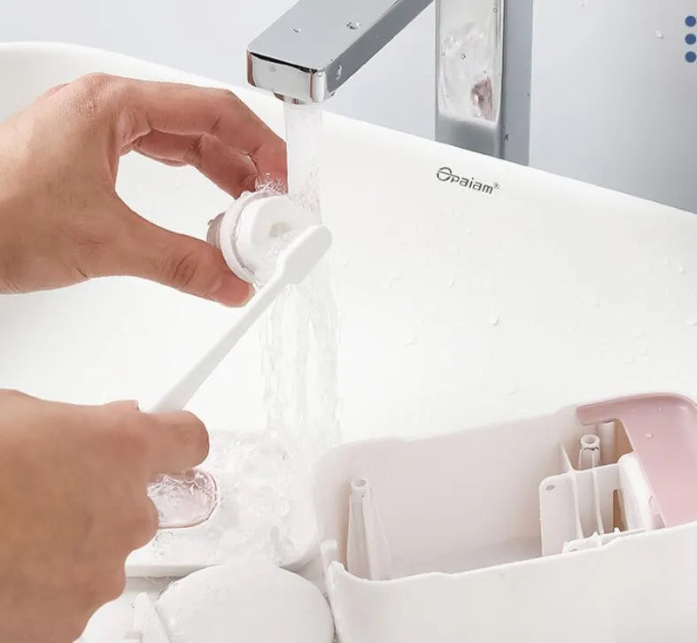 Blue automatic toothpaste dispenser with wall-mount bracket on a bathroom wall