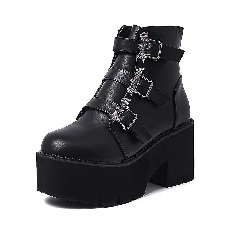 Black women's punk ankle boots with bat buckle, side zipper, thick heel, and round toe.