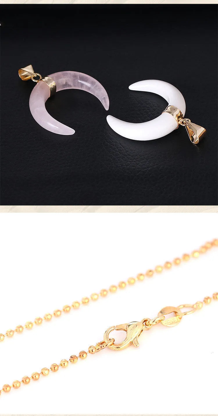 A pink semi-precious stone moon pendant on a copper-coloured chain, laid flat.