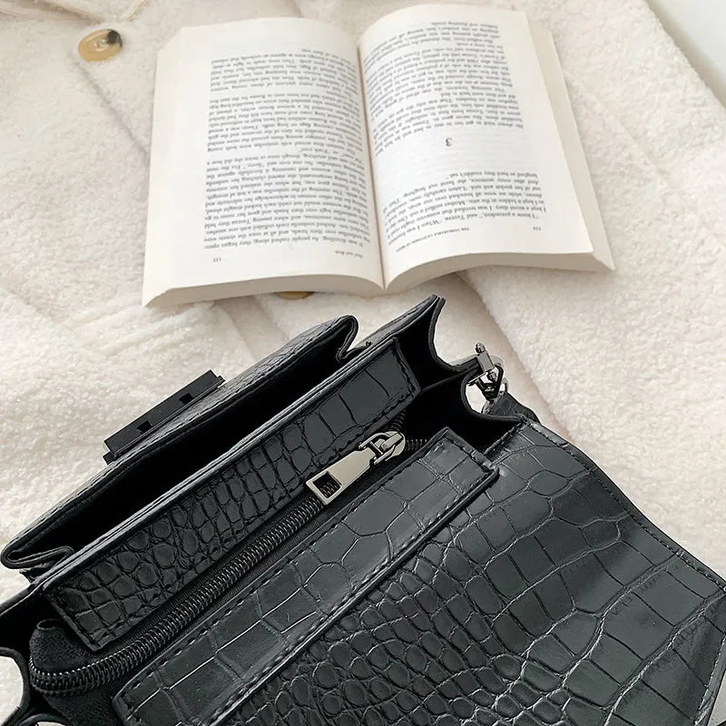 Vintage PU leather crossbody bag in black showing 20cm width and crossbody strap