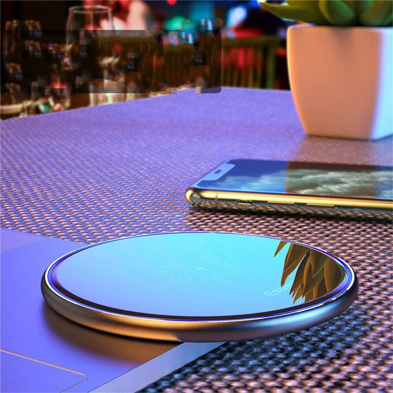Black wireless charging pad with LED indicator light for smartphones and headphones