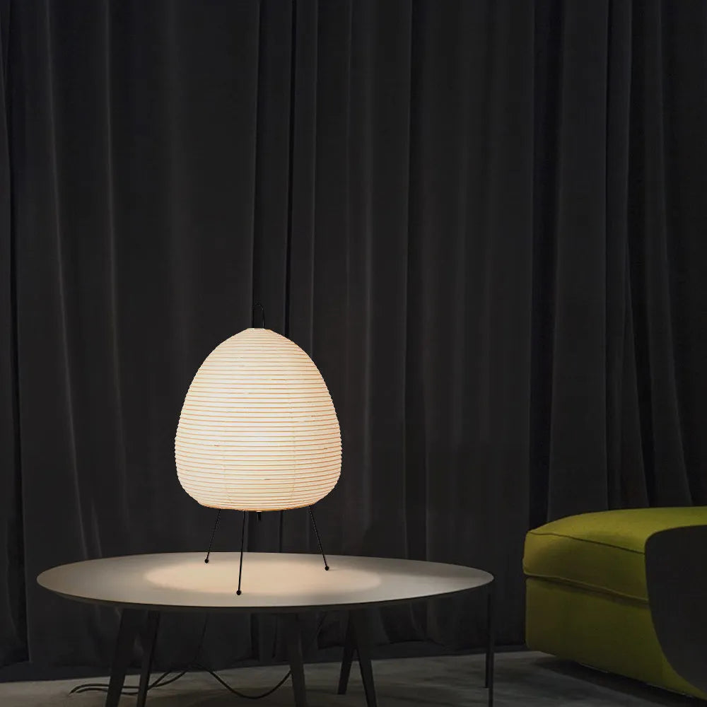 Japanese style table lamp with rice paper shade and aluminium base showing warm glow