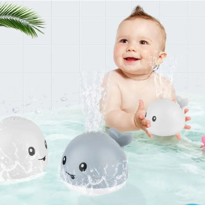 Automatic electric whale bath toy spraying water with flashing coloured lights